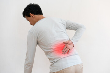 Back pain, man suffering from backache highlighted in red area , isolate white background
