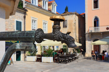 Close up view of copper tap of water well in Herceg Novi, Montenegro