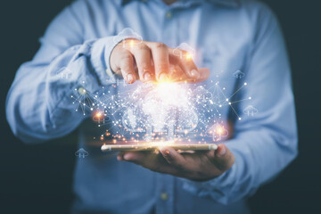 Businessman holding smartphone with cloud computing, earth virtual, and network line on hand....