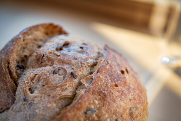 Fragment of the wheat round bread with sprouted grains and sunflower seeds. Macro view of the wheat round bread surface with sprouted grains