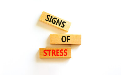 Signs of stress symbol. Concept words Signs of stress on wooden blocks. Beautiful white table white background. Psychological business and signs of stress concept. Copy space.