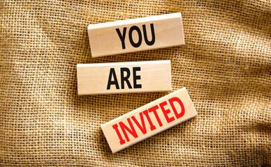 You are invited symbol. Concept words You are invited on wooden blocks. Beautiful canvas table canvas background. Business and you are invited concept. Copy space.