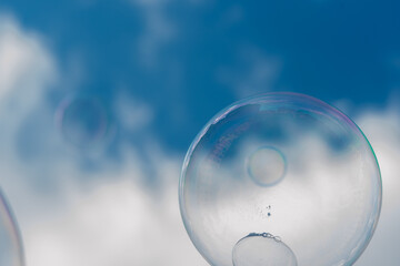 Soap bubbles are flying in the blue sky