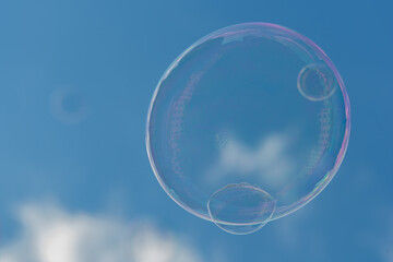 Soap bubbles are flying in the blue sky