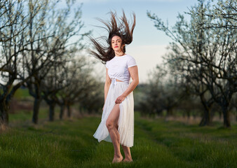 Beautiful woman in a plum orchard in bloom