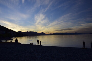 San Carlos de Bariloche, Argentina- 05 march 2017: Tourists rest on pebble beach of Nahuel Huapi Lake, Night shot