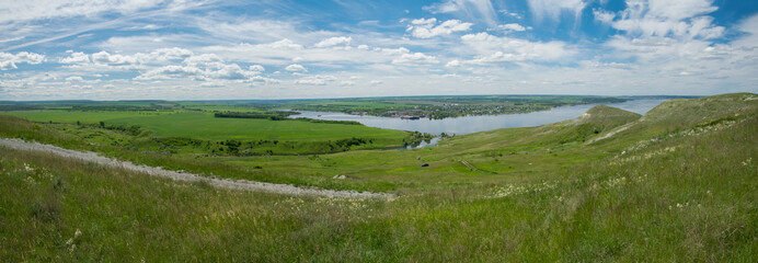 Sunny view on panorama of the Volga river. landscape with green hills, a clear summer sky and a river