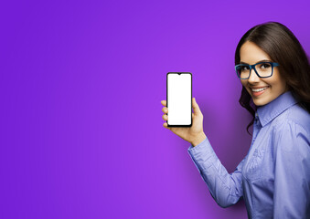 Portrait image of happy smiling young woman in eye glasses holding showing smartphone cell phone...