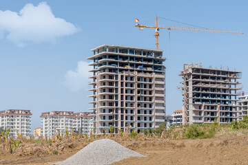Construction of new residential buildings on the background of a residential area.