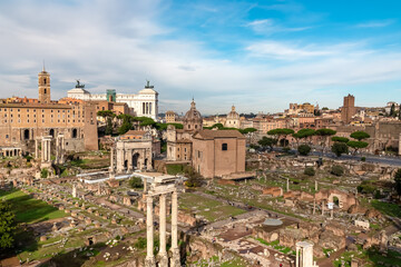 Fototapeta premium Panoramic view on ancient ruins of Roman Forum and Rome Skyline from Palatine Hill in city of Rome, Lazio, Italy, Europe, EU. Looking on Antoninus and Faustina Temple, Victor Emmanuel II monument