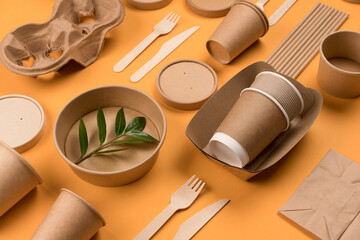 Eco-friendly tableware - kraft paper food packaging on orange background. Street food paper...