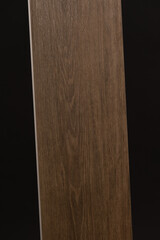 Porcelain stoneware tile designed in the form of a tree on a dark gray background