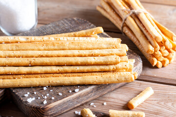 Breadsticks grissini. Bread sticks with salt on table