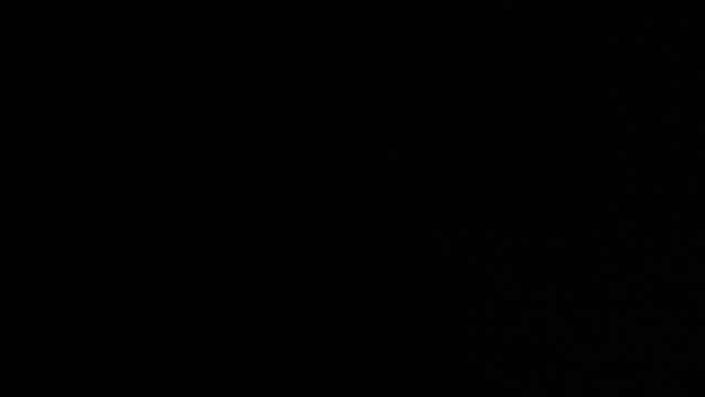 Broken phone screen in the dark with police flashing lights. Cracked phone glass close up on black background