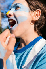 Young fan of the Argentine soccer team shouts the goals of the World Cup.