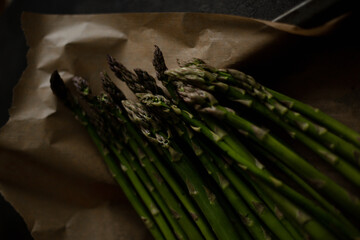 hand holding asparagus on table