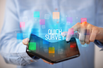 Young man holding a foldable smartphone