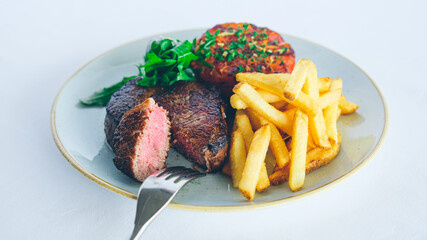 Medium rare sirloin steak with garnish