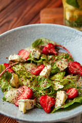 Bright salad with strawberry, spinach and blue cheese.