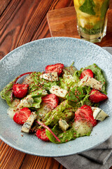 Bright salad with strawberry, spinach and blue cheese.