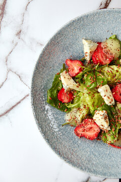 Bright salad with strawberry, spinach and blue cheese.