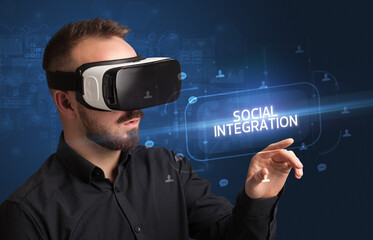 Businessman looking through Virtual Reality glasses, social media concept