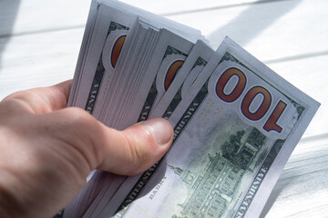 Money, US dollar bills background. Hands holding dollar bills