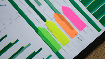 Colored sticker stripes on business analytics chart closeup