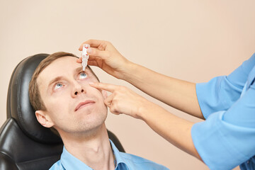 ophthalmologist medical patient. eyedrop apply. Eye clinic treatment. Hospital optics equipment....