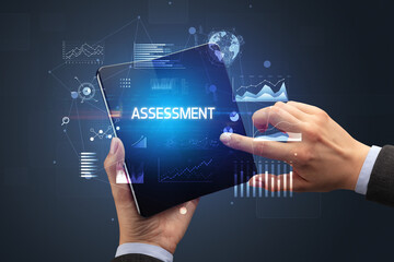 Businessman holding a foldable smartphone, business concept