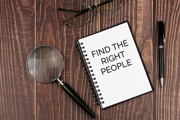 Find the right people text on note pad with calculator and pen on wood background concept -...