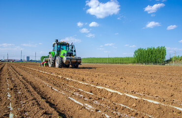 Fototapeta premium Mechanized agricultural sowing in spring