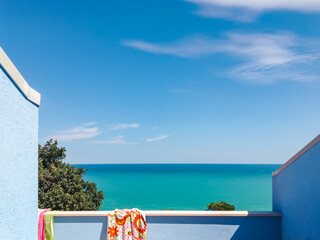 View of the sea from terrace in a holiday home on a sunny summer day. Adriatic Sea seen from a resort. Panoramic view of the sea on the Adriatic coast, Abruzzo, Italy. - obrazy, fototapety, plakaty