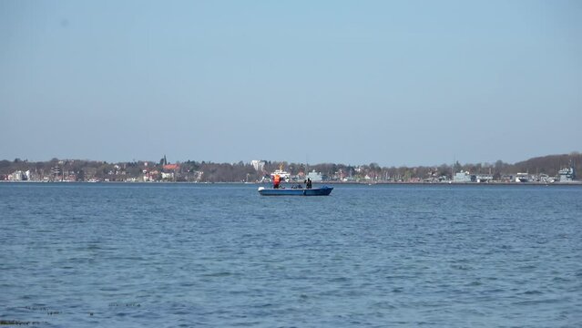 Two men fishing from a boat on the Baltic Sea off Eckernfoerde.