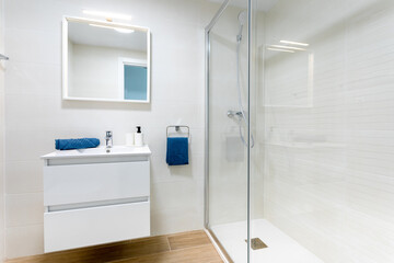 A modern, minimalist, white bathroom with a shower. - 504435622