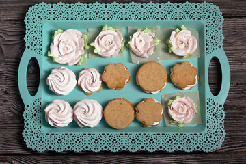 Homemade marshmallows and marshmallow sandwiches. Zephyr in the form of roses with green leaves....