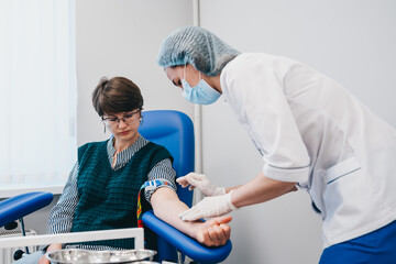 The patient takes a blood test at the clinic.