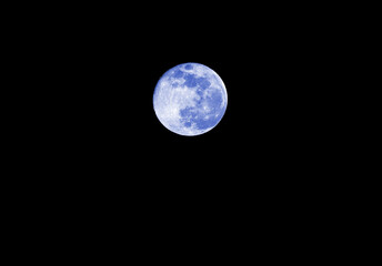 Blue moon on the absolutely black sky
