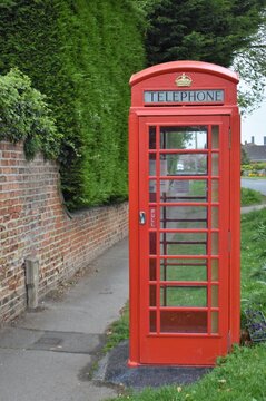 Red phone box in a village