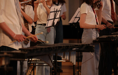 A group of students young people women and men play in a jazz band on musical instruments...