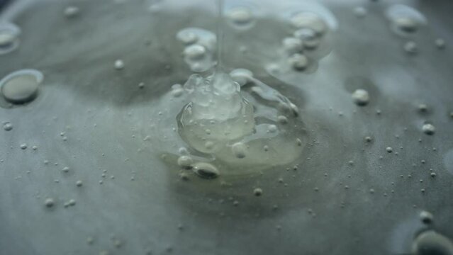 Squeeze Out A Transparent Gel On The Background