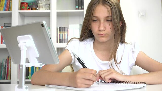 Young Girl Writing at Laptop in Online Education, Student Child Learning, Studying in Coronavirus Pandemic, Kid Working Homework
