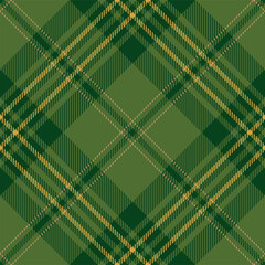 Green and yellow argyle tartan plaid. Scottish pattern fabric swatch close-up. 