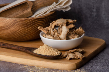 Dry ginger in a spoon. Dry ginger powder. Ginger dry pieces