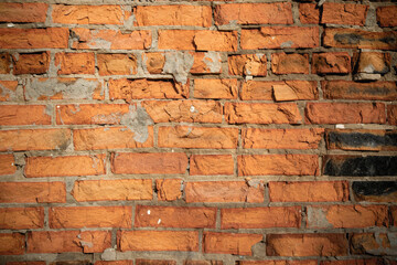 An old weathered brick wall fragment. Close-up of the destroyed wall