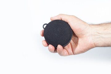 wireless speaker in hand isolated on white surface