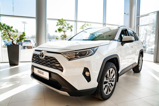 new white car white Toyota rav4 in premises of dealership 
