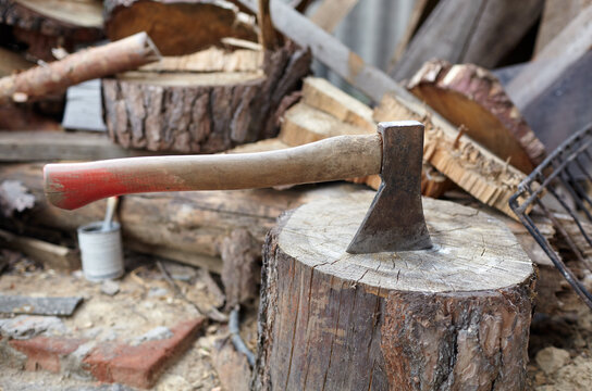 Ax in the stump. Axe for cutting wood. Preparation of firewood for the winter. Selective focus, blurred background