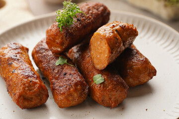 Traditional south european skinless sausages cevapcici made of ground meat and spices on white...