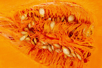 Pumpkin seeds inside a cut fruit